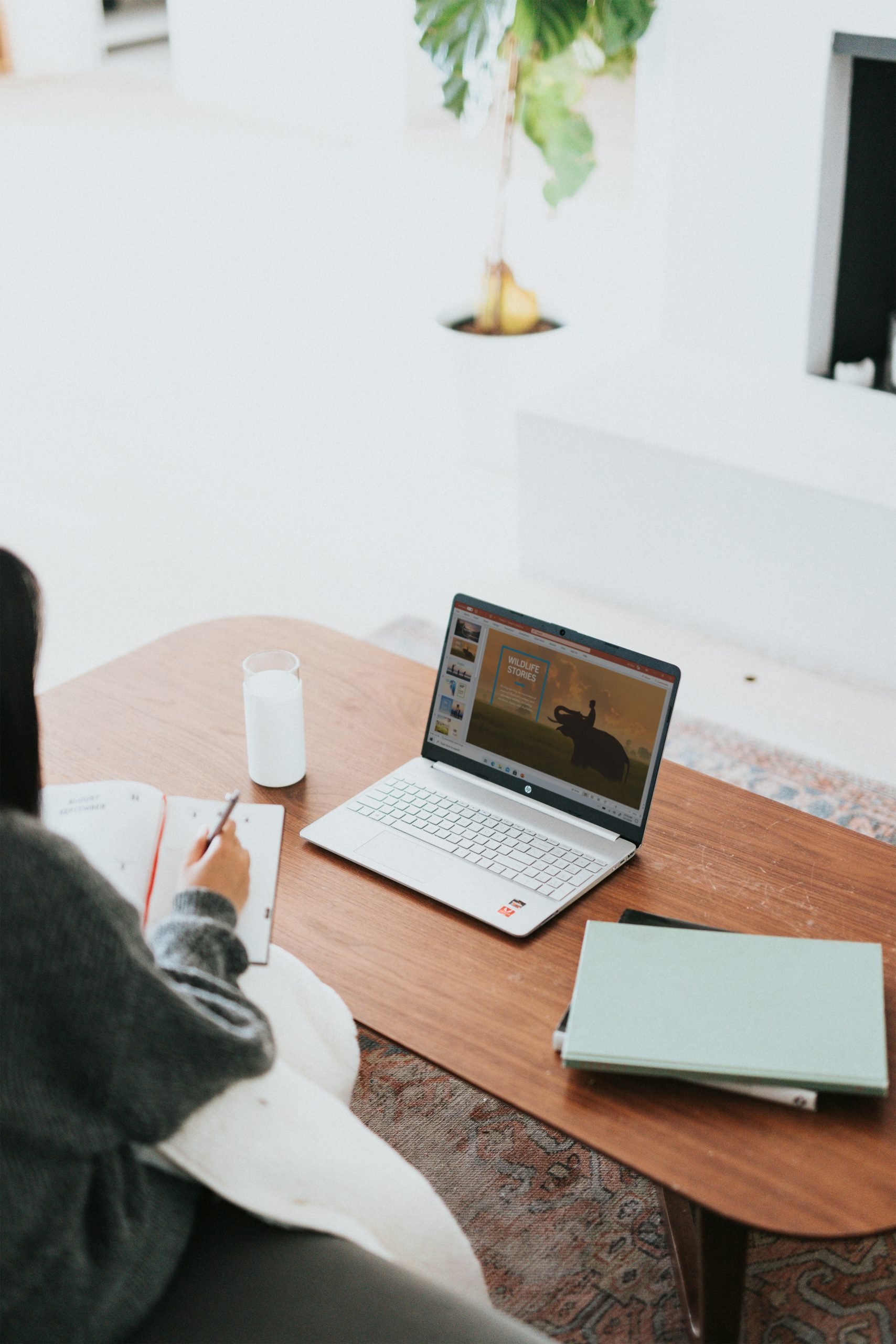 windows-W1N58KDE8r0-unsplash DIY Your Website Business Tools (woman sat at desk taking notes)
